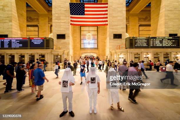 Activist group Gays Against Guns held a silent vigil in Grand Central Station to help raise awareness about PTSD bringing their iconic Human Beings -...