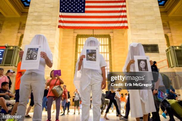 Activist group Gays Against Guns held a silent vigil in Grand Central Station to help raise awareness about PTSD bringing their iconic Human Beings -...