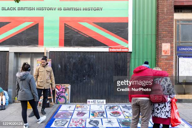 Black artist is seen selling his paintings in Camden Town during the Black History Month as cases of Covid-19 rise during the second wave of...