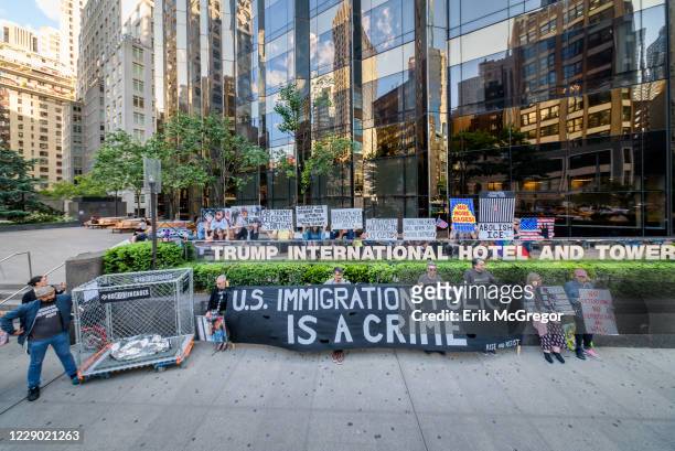 Activist holding placards and banner during the demonstration on Trumps birthday outside the Trump International Hotel to peacefully draw attention...