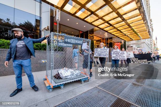 Activist holding placards during the demonstration on Trumps birthday outside the Trump International Hotel to peacefully draw attention to the...