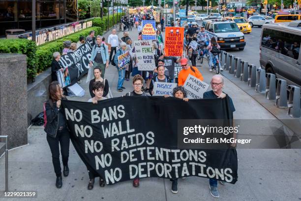 Activist holding placards and banner during the demonstration on Trumps birthday outside the Trump International Hotel to peacefully draw attention...