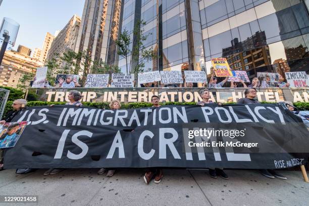 Activist holding placards and banner during the demonstration on Trumps birthday outside the Trump International Hotel to peacefully draw attention...