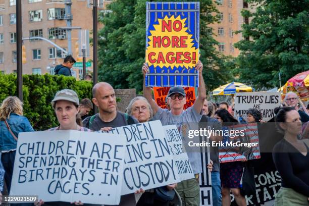 Activist holding placards during the demonstration on Trumps birthday outside the Trump International Hotel to peacefully draw attention to the...