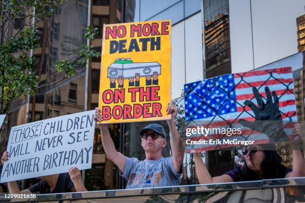 Activist holding placards during the demonstration on Trumps birthday outside the Trump International Hotel to peacefully draw attention to the...