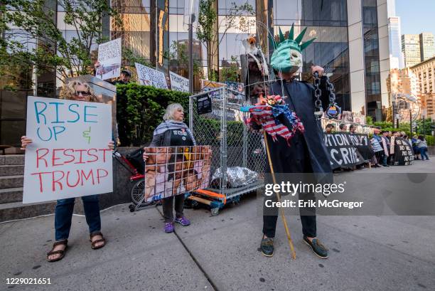 Activist holding placards during the demonstration on Trumps birthday outside the Trump International Hotel to peacefully draw attention to the...