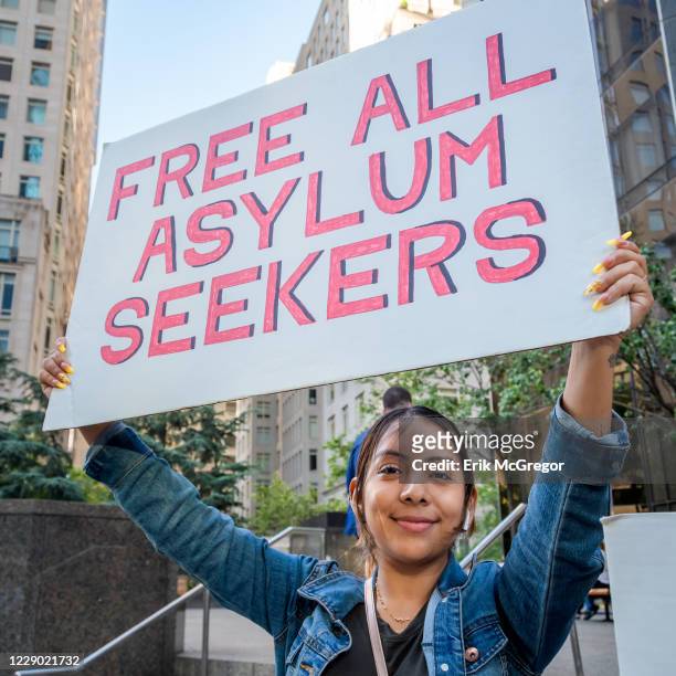 An activist holding a placard during the demonstration on Trumps birthday outside the Trump International Hotel to peacefully draw attention to the...