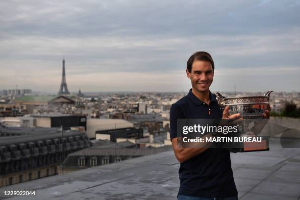 Spain's Rafael Nadal holds the Mousquetaires Cup during a photocall a day after winning the men's singles of The Roland Garros 2020 French Open...