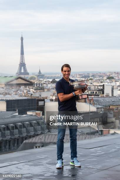 Spain's Rafael Nadal holds the Mousquetaires Cup during a photocall a day after winning the men's singles of The Roland Garros 2020 French Open...