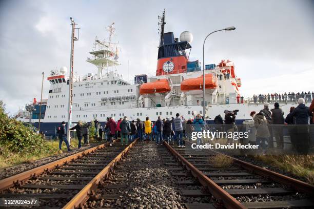 Friends and family follow the Polarstern research vessel returns from a year-long drift across the Arctic on October 12, 2020 in Bremerhaven,...