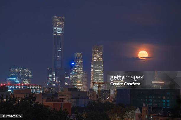 Bright moon rises in the CBD night sky. Beijing, China, September 2, 2020. -