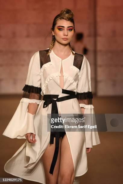 In this image released on October 12, A model walks the runway during the Belma Özdemir show during Mercedes-Benz Istanbul Fashion Week at Tophane-...
