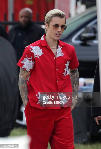 Justin Bieber wears a striking red outfit with his platinum hair slicked back as he prepares to shoot a Cuban themed video on February 27, 2020 in...