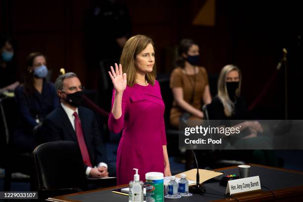 Supreme Court nominee Judge Amy Coney Barrett swears in before the Senate Judiciary Committee on the first day of her Supreme Court confirmation...