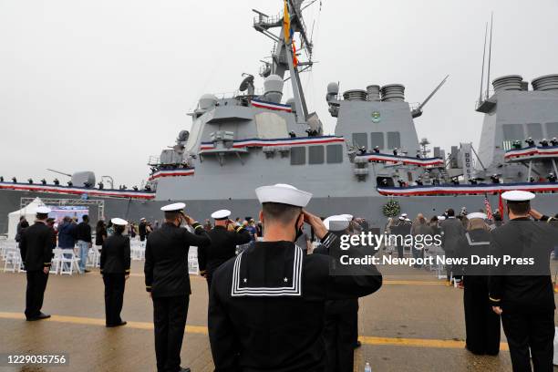 Sailors salute the presentation of colors during a remembrance ceremony commentating the 20th anniversary of the attack on USS Cole Monday morning,...