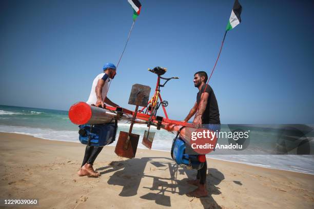 Palestinian youth Muhammad Al-Radi takes his pedal boat for a test ride, which he made from scrap iron and plastic during the lockdown imposed as a...