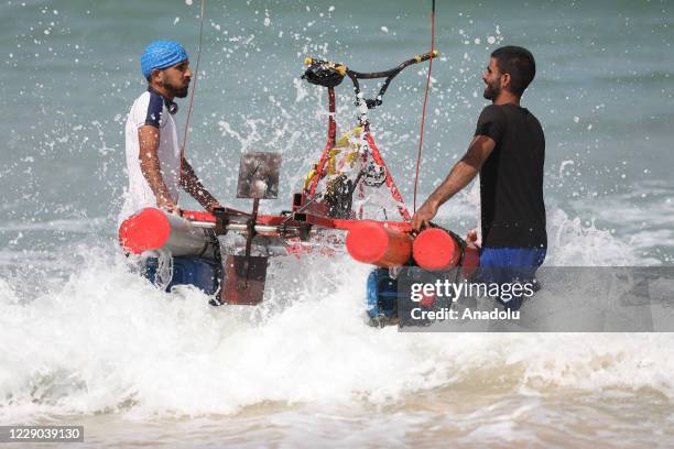 Palestinian youth Muhammad Al-Radi takes his pedal boat for a test ride, which he made from scrap iron and plastic during the lockdown imposed as a...