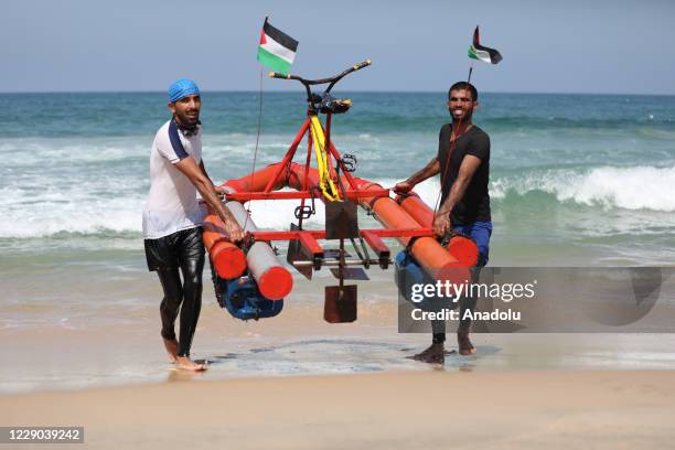 Palestinian youth Muhammad Al-Radi takes his pedal boat for a test ride, which he made from scrap iron and plastic during the lockdown imposed as a...