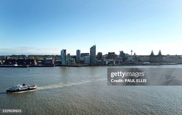 An aerial picture shows a ferry crossing the River Mersey in Liverpool, north west England on October 13 as new local lockdown measures are set to be...