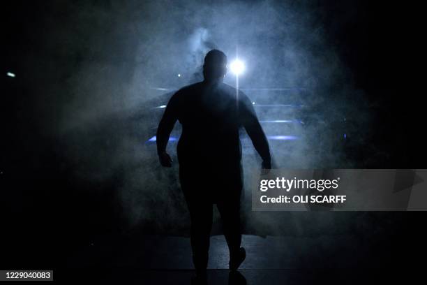Professional wrestler Mickey Barnes enters the ring to take part in a bout during an evening of wrestling entertainment presented by promoter...