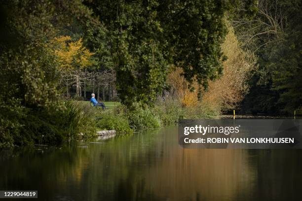 Woman sits on the bench near the river Kromme Rijn on an autumn day in Bunnik, The Netherlands, on October 13, 2020. / Netherlands OUT - Belgium OUT