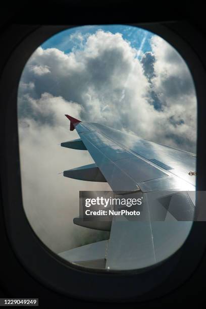 Wing view from the window of the plane with clouds during the flight. Flying with Lauda Airbus A320 airplane with registration 9H-LMJ during the...