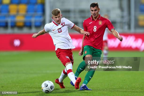 Mateusz Bogusz of Poland and Iliya Yurukov of Bulgaria compete for the ball during the UEFA Euro Under 21 Qualifier match between Poland U21 and...
