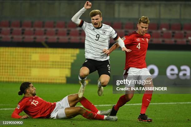 Switzerland's defender Ricardo Rodriguez , Germany's forward Timo Werner and Switzerland's defender Nico Elvedi vie for the ball during the UEFA...