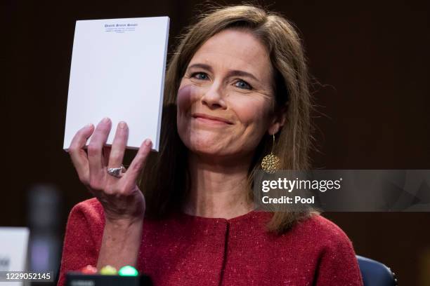 Supreme Court justice nominee Amy Coney Barrett holds up her notepad at the request of Sen. John Cornyn, R-Texas, on the second day of her Senate...