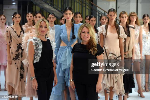 In this image released on October 13, Fashion designer Nedret Taciroglu poses with models after the Nedo by Nedret Taciroglu show during...