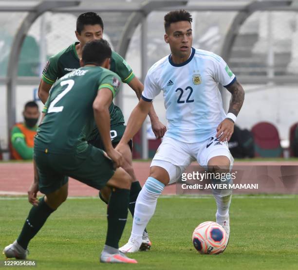 Argentina's Lautaro Martinez is marked by Bolivia's Gabriel Valverde during their 2022 FIFA World Cup South American qualifier football match at the...