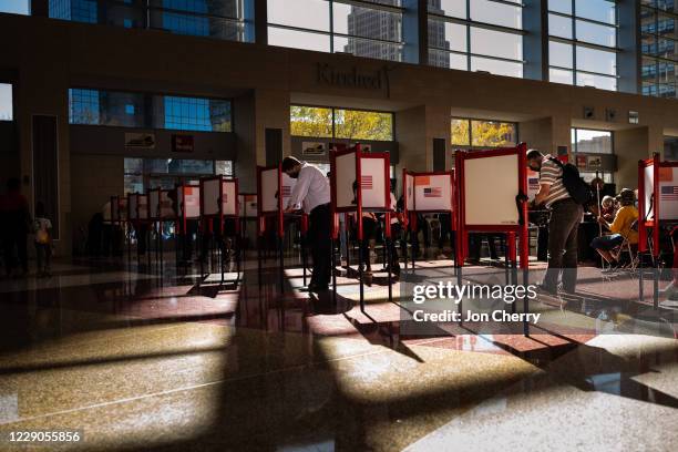 Voters fill out their ballots at the KFC YUM! Center on October 13, 2020 in Louisville, Kentucky. Tuesday marked the first day of early in-person...