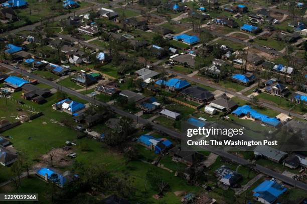 Blue tarps cover the roofs of homes, which were damaged after Hurricane Laura and Hurricane Delta landed in southwest Louisiana in Lake Charles,...