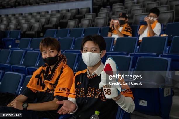 Young fans sit in socially distanced seats as they wait to watch the Japan Central League baseball match between Yomiuri Giants and Hiroshima Carp at...