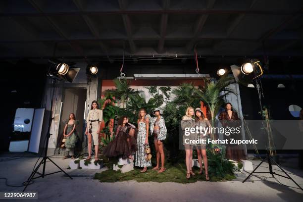 In this image released on October 14, Models pose during the Sudi Etuz presentation during Mercedes-Benz Istanbul Fashion Week at Galataport Rhtm &...