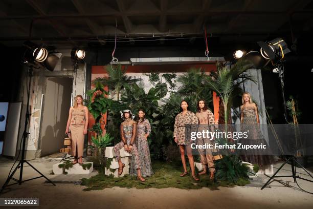 In this image released on October 14, Models pose during the Sudi Etuz presentation during Mercedes-Benz Istanbul Fashion Week at Galataport Rhtm &...