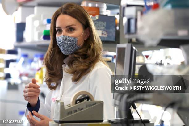 Britain's Catherine, Duchess of Cambridge, tours a laboratory, during a visit to the Institute of Reproductive and Development Biology at Imperial...