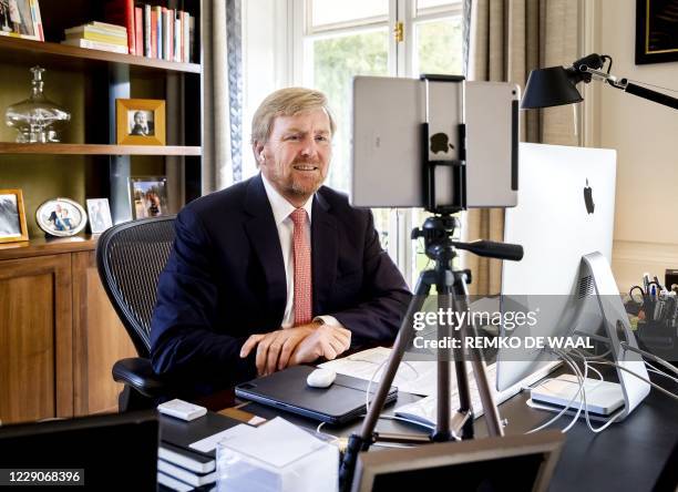 Dutch King Willem-Alexander talks to the chairman of the General Practitioners Association of Aruba during a video call with the medical sector in...