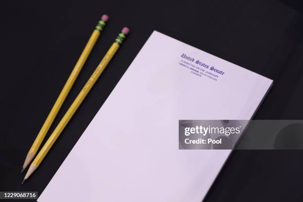 Blank notepad and pencils are seen at the witness table of Supreme Court nominee Judge Amy Coney Barrett as she testifies before the Senate Judiciary...