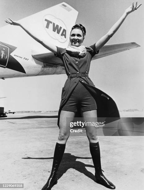 Flight attendant presents the new uniform from the Trans World Airlines company created by designer Valentino on June 2, 1971.