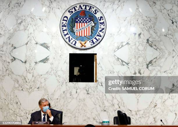 Chairman Lindsey Graham waits for the microphones to be repaired during a break in the Senate Judiciary Committee confirmation hearing for Supreme...