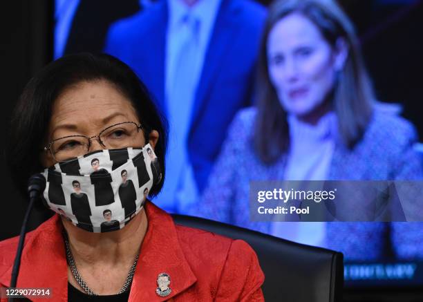 Sen. Mazie Hirono , wearing a face mask depicting illustrations of the late Justice Ruth Bader Ginsburg, listens as Supreme Court nominee Judge Amy...