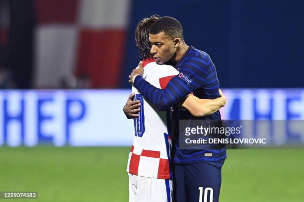 France's forward Kylian Mbappe embraces Croatia's midfielder Luka Modric after the UEFA Nations League Group A3 football match between Croatia and...
