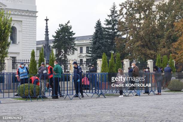 Police checks outside the Metropolitan Cathedral of Iasi, to visitors in line to venerate Saint Parascheva, also known as Saint Petka, the miraculous...