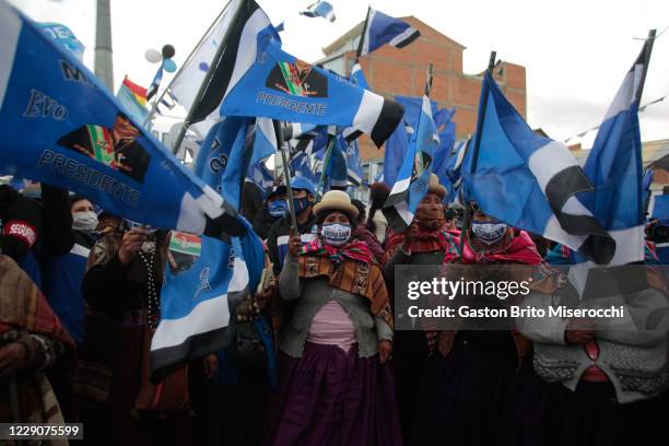 Demonstrators hold flags with the face of former president Evo Morales during a MAS closing rally ahead of Presidential elections on October 14, 2020...