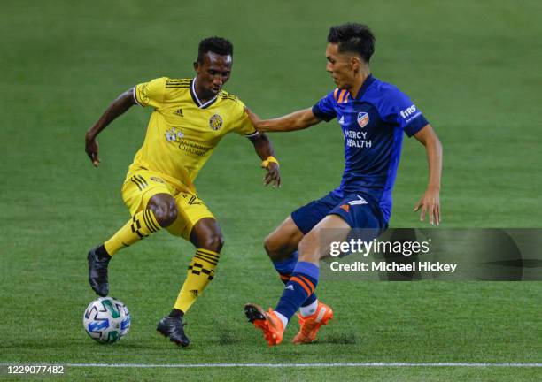 Yuya Kubo of FC Cincinnati battles for the ball against Fatai Alashe of the Columbus Crew at Nippert Stadium on October 14, 2020 in Cincinnati, Ohio.