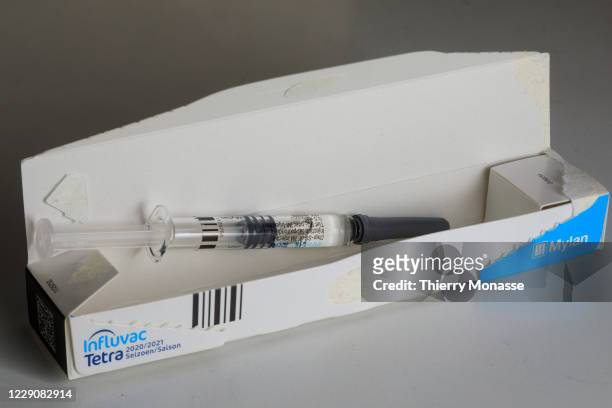 Flu vaccine syringe rests on a table on October 14, 2020 in Brussels, Belgium. The seasonal flu vaccine is made up of two strain A viruses and one...
