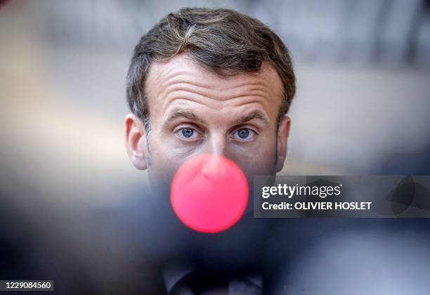 French President Emmanuel Macron, speaks on camera as he arrives ahead of a two days European Union summit at the European Council Building in...