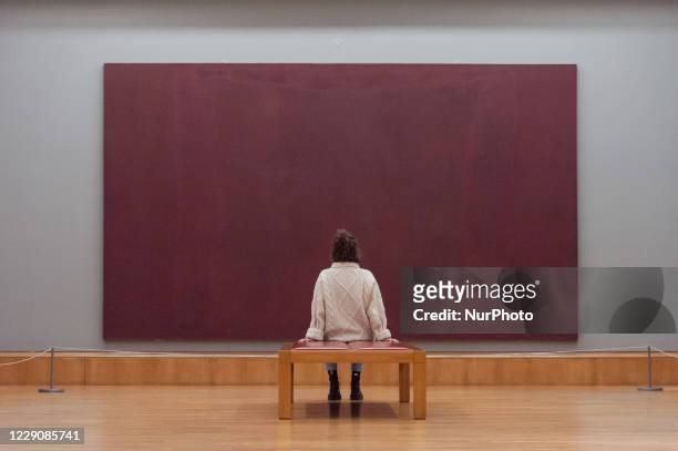 Editorial Use Only)Gallery staff member looks at Mark Rothko's The Seagram Murals: Red on Maroon oil paint, pigment and glue on canvas during a...