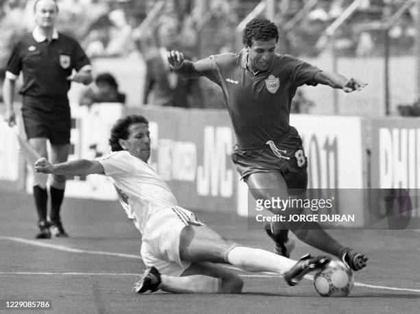 Portugal's Jose Pimental tackles Morocco's Bouderbala El Idrissi , 11 June 1986 in Guadalajara, during the the World Cup soccer match between...
